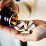 Woman taking vitamin pills