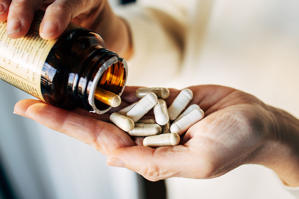 Woman taking vitamin pills